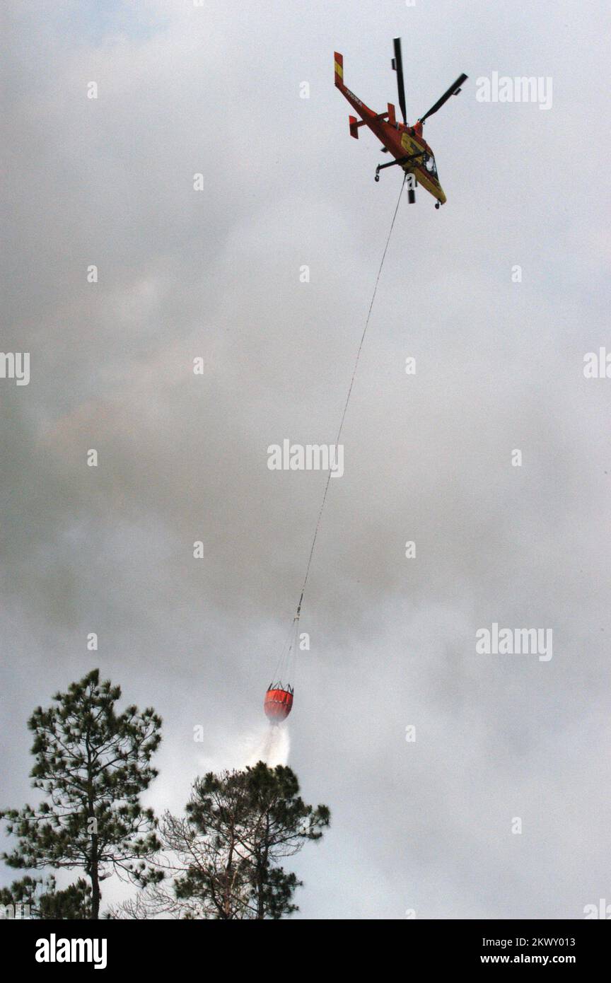 Lake City, FL, May 15, 2007 A helicopter drops a load of water on a
