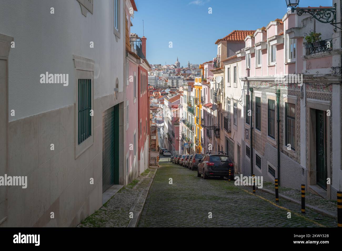 Narrow street with city view and National Pantheon dome on background - Lisbon, Portugal Stock Photo