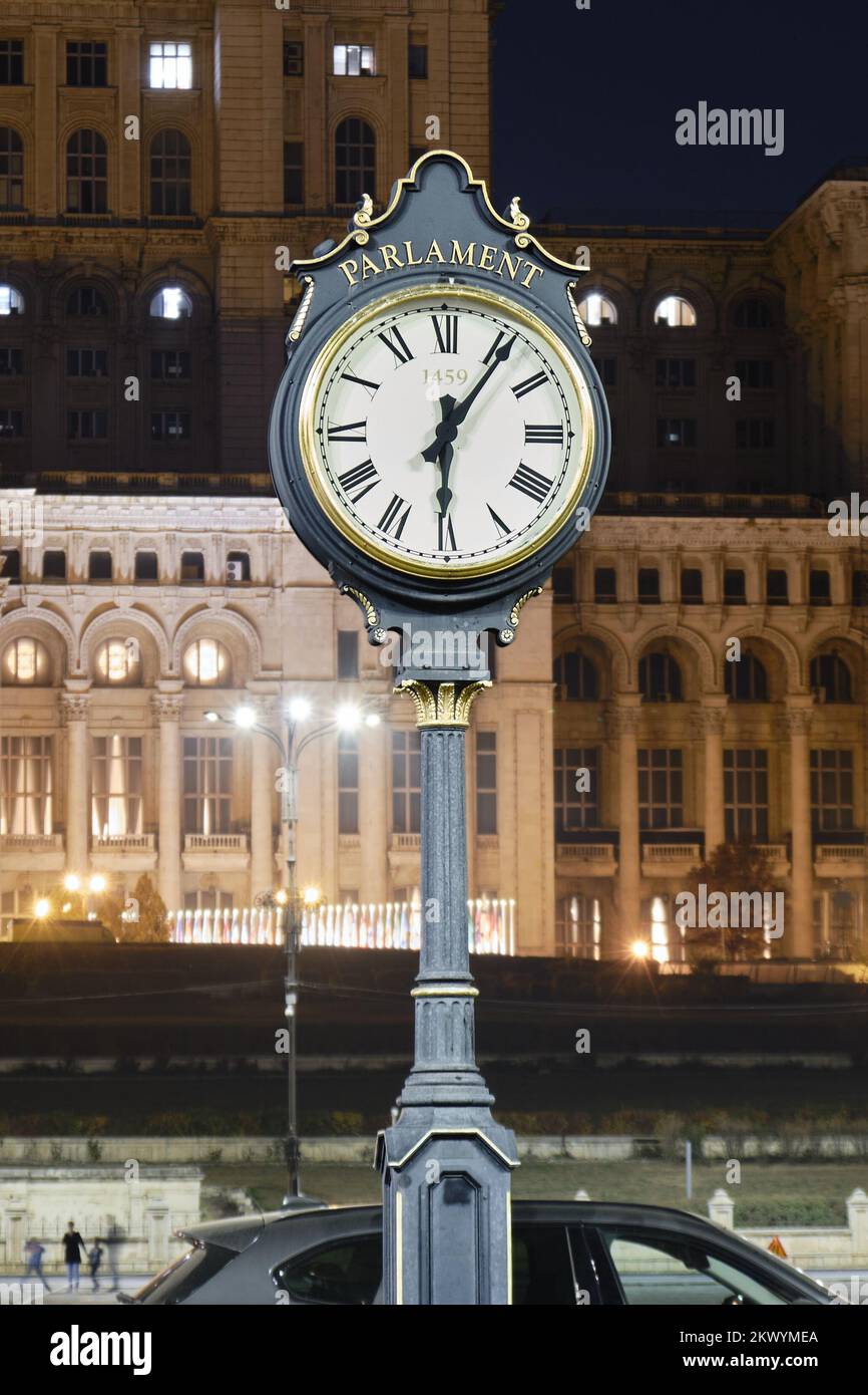 Public clock at Palace of Parliament, Bucharest, Romania, partly illuminated at night to reduce