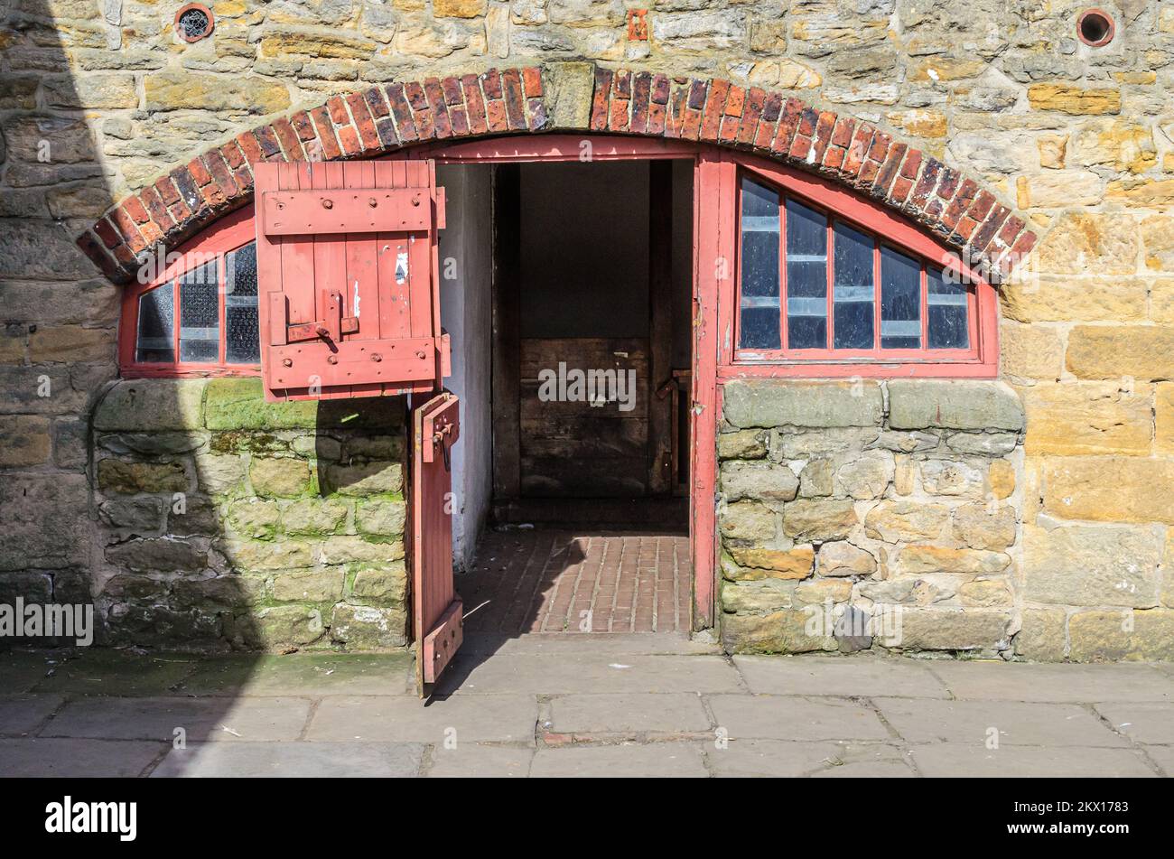 Old stone built farm shed with an open door Stock Photo