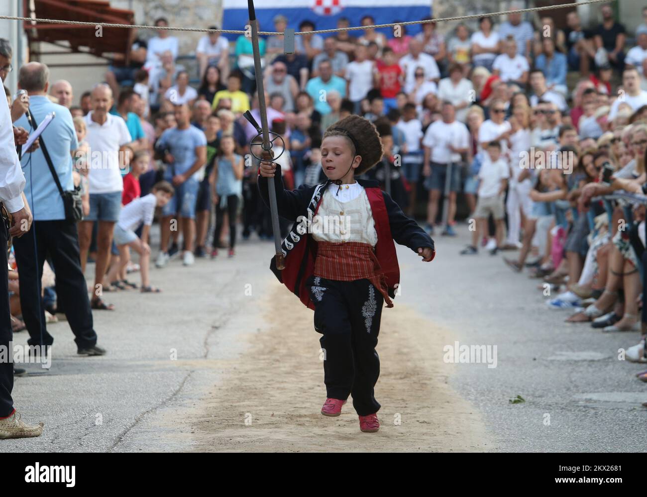 20.08.2017., Brnaze, Croatia - Alkar Vito Vuckovic runs during the Children's Alka tournament in Vuckovici village, Croatia, August 20, 2017. Children's Alka is a tournament which has been held every August in the Croatian village of Vuckovici since 1955. in memory of their ancestors Father Pavao, Boze, Tadija and Zec, whose heroism and bravery made them become prominent in the decisive battle against the Ottomans in 1715. Only boys up to 10 years can participate. Photo: Ivo Cagalj/PIXSELL Stock Photo