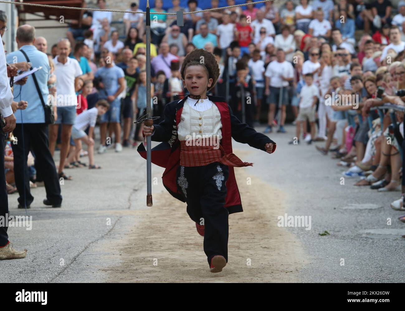 20.08.2017., Brnaze, Croatia - Alkar Vito Vuckovic runs during the Children's Alka tournament in Vuckovici village, Croatia, August 20, 2017. Children's Alka is a tournament which has been held every August in the Croatian village of Vuckovici since 1955. in memory of their ancestors Father Pavao, Boze, Tadija and Zec, whose heroism and bravery made them become prominent in the decisive battle against the Ottomans in 1715. Only boys up to 10 years can participate. Photo: Ivo Cagalj/PIXSELL Stock Photo