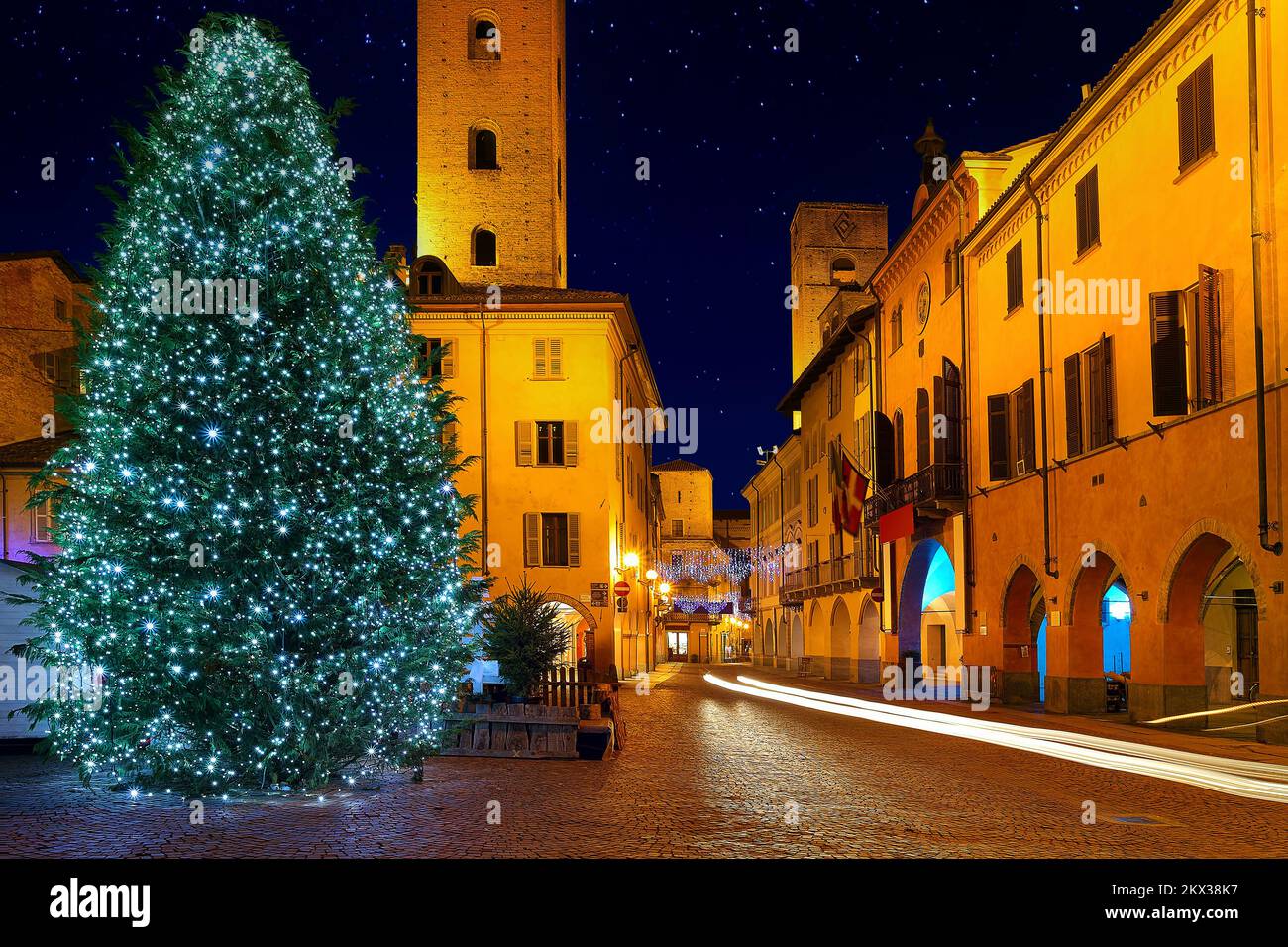 Illuminated Christmas tree on city central square in town of Alba, Italy. Stock Photo