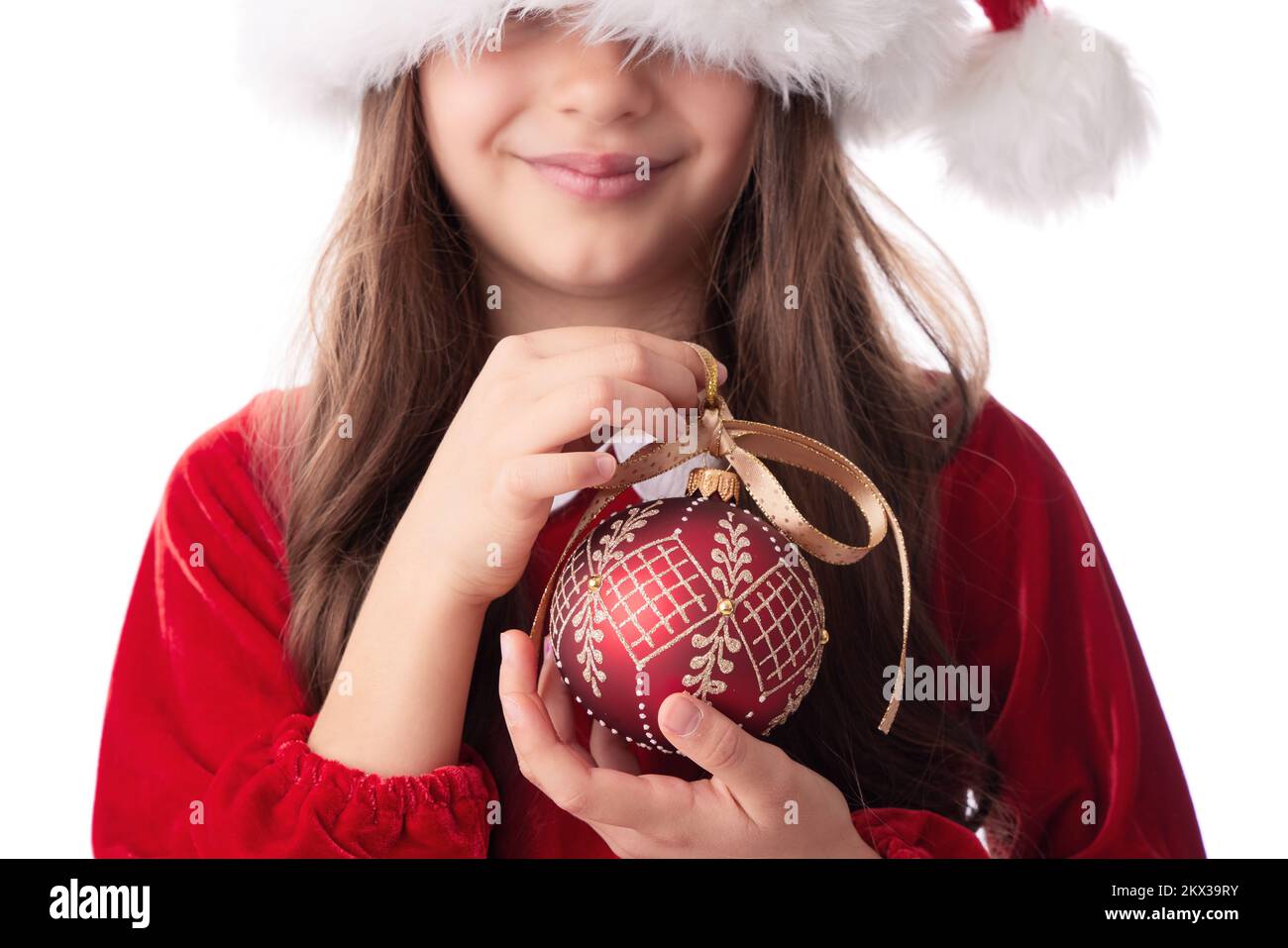 Smiling woman with Christmas tree shining ball, bauble, girl posing in red dress of Santa Claus on white background Stock Photo