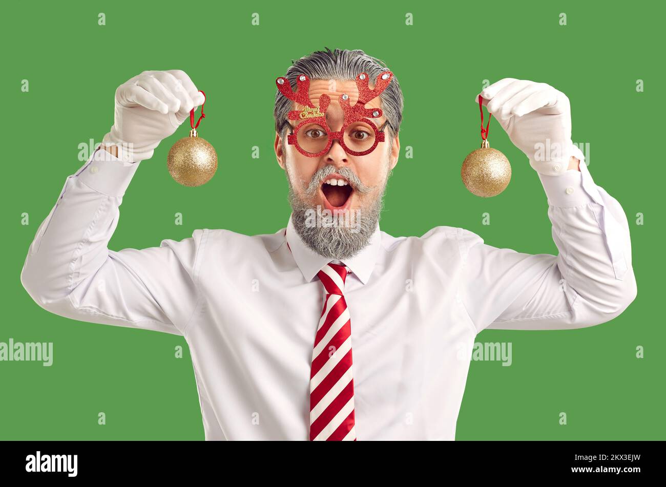 Happy surprised man in funny reindeer antler glasses having fun at Christmas party Stock Photo