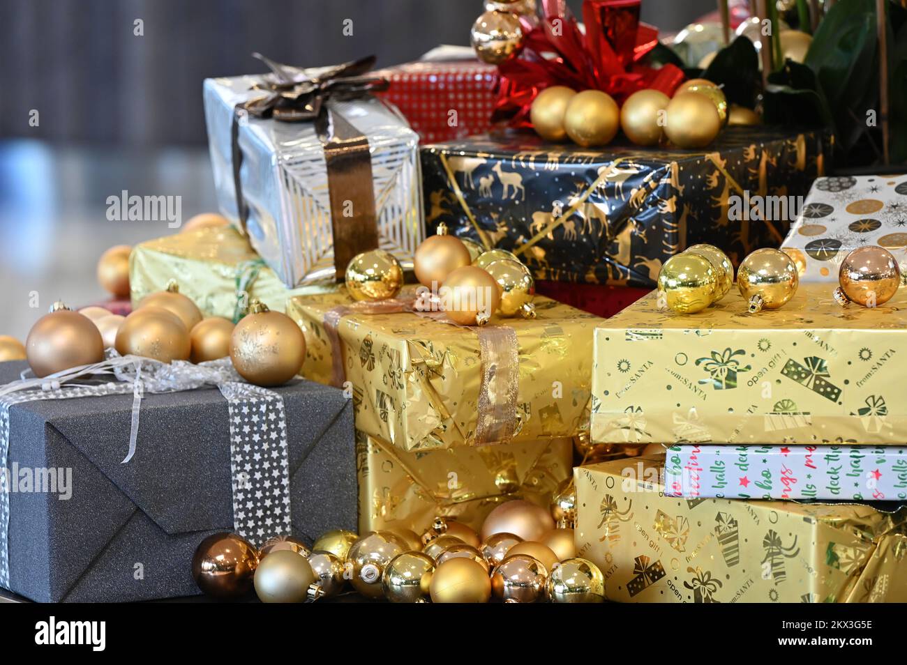 Various Christmas packages and golden balls on a table Stock Photo