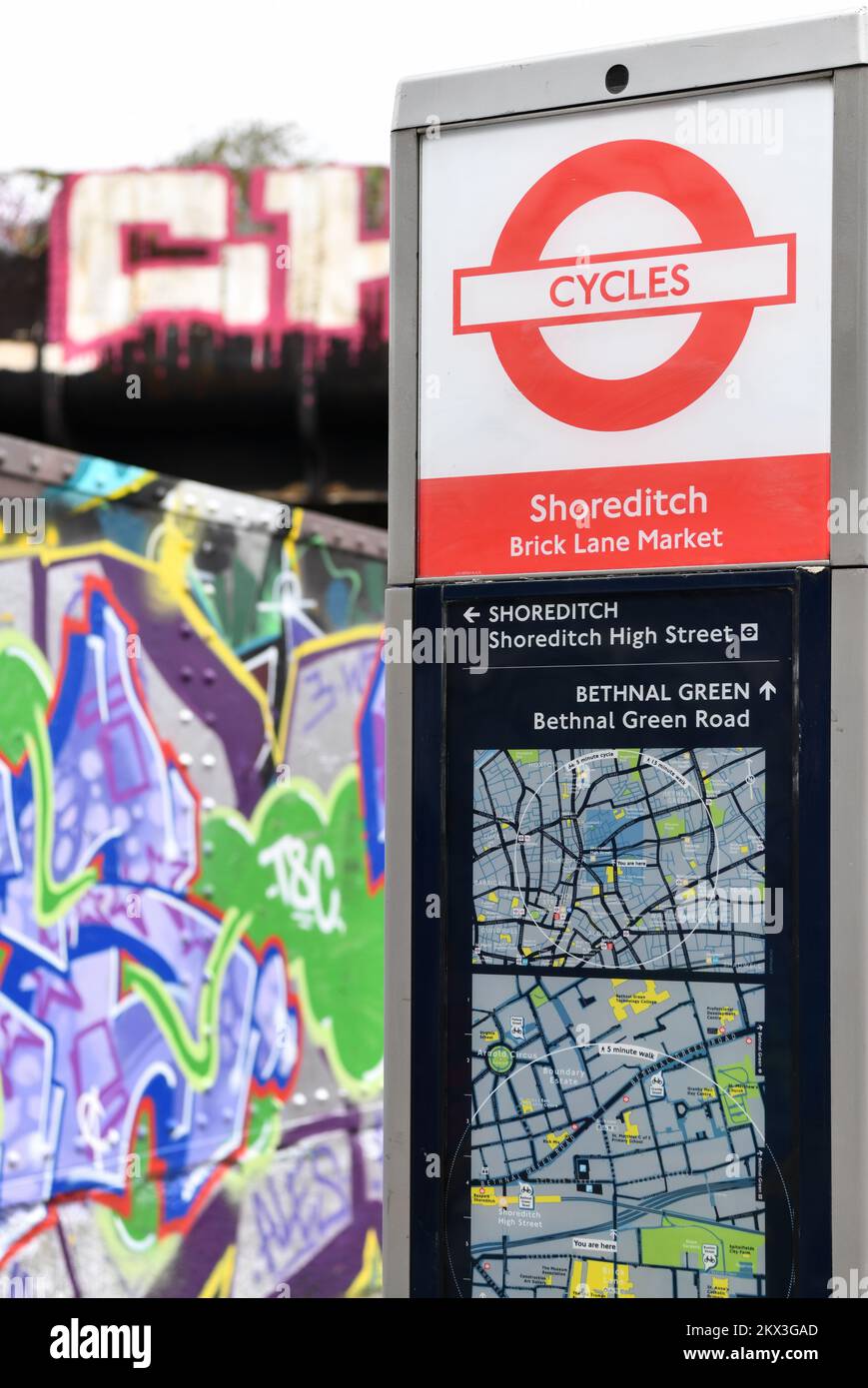 Transport for London Santander Cycles Information Point in Brick Lane with graffiti behind, Shoreditch, London Stock Photo