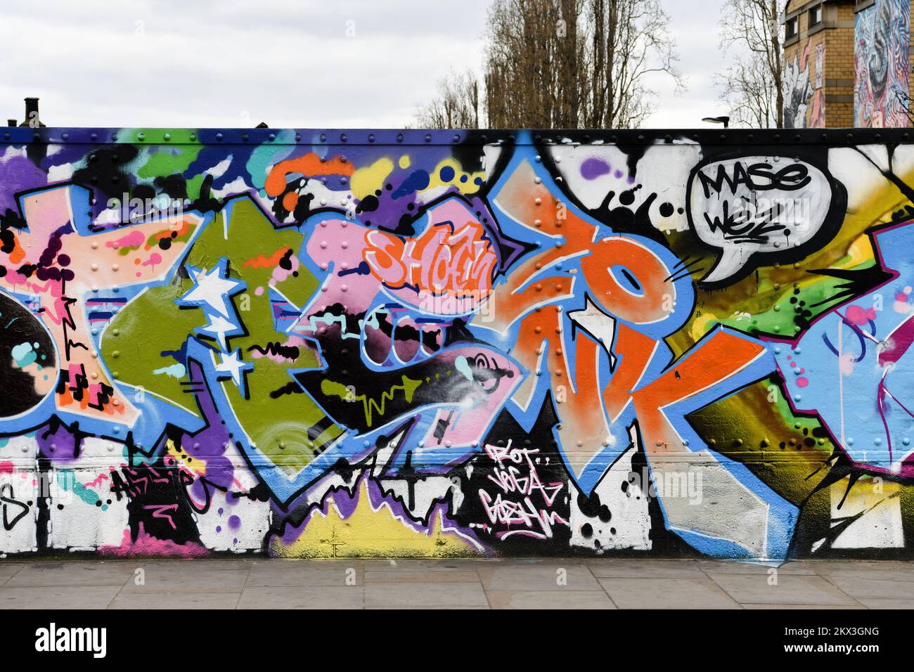 Graffiti on Brick Lane with flats behind Shoreditch London Stock Photo