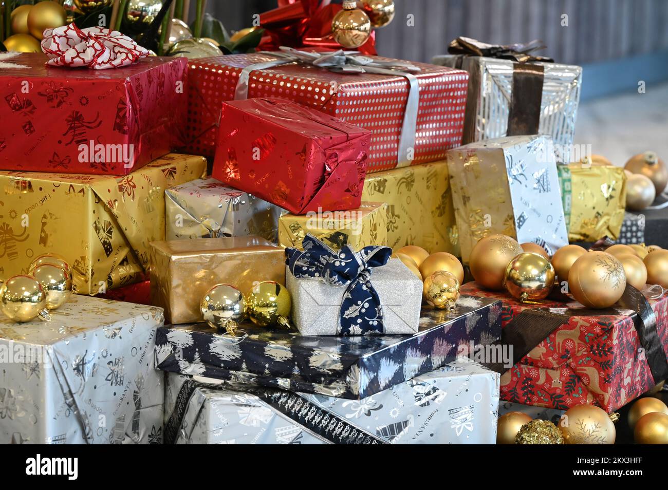 Various Christmas packages and golden balls on a table Stock Photo