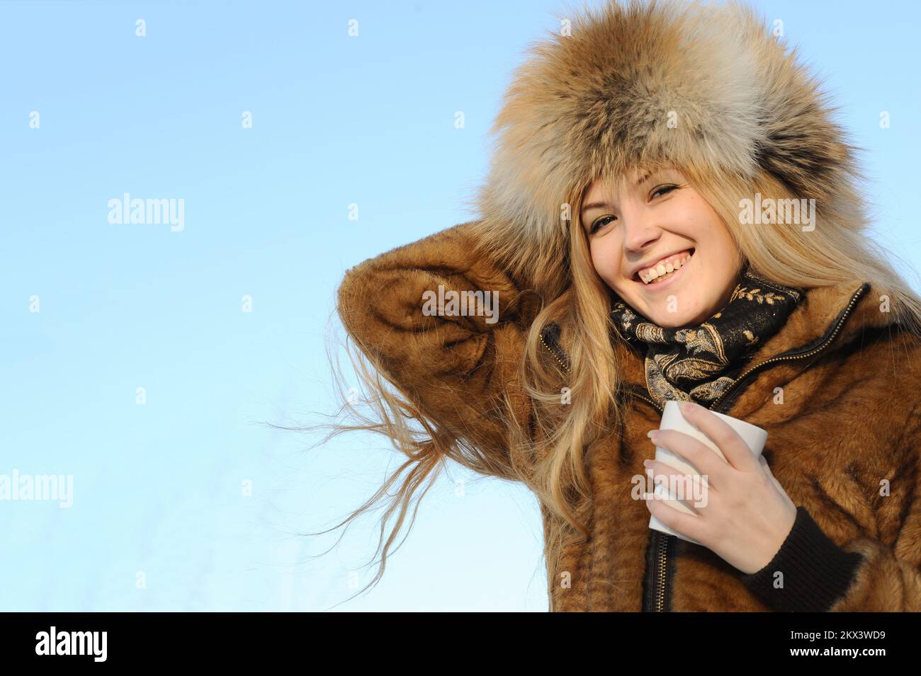 Outdoor portrait of young caucasian woman in fur hat Stock Photo - Alamy