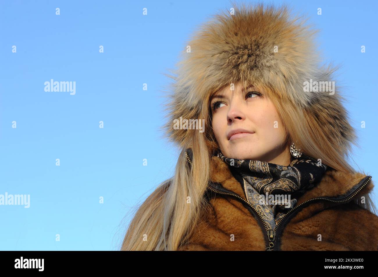 Outdoor portrait of young caucasian woman in fur hat Stock Photo - Alamy