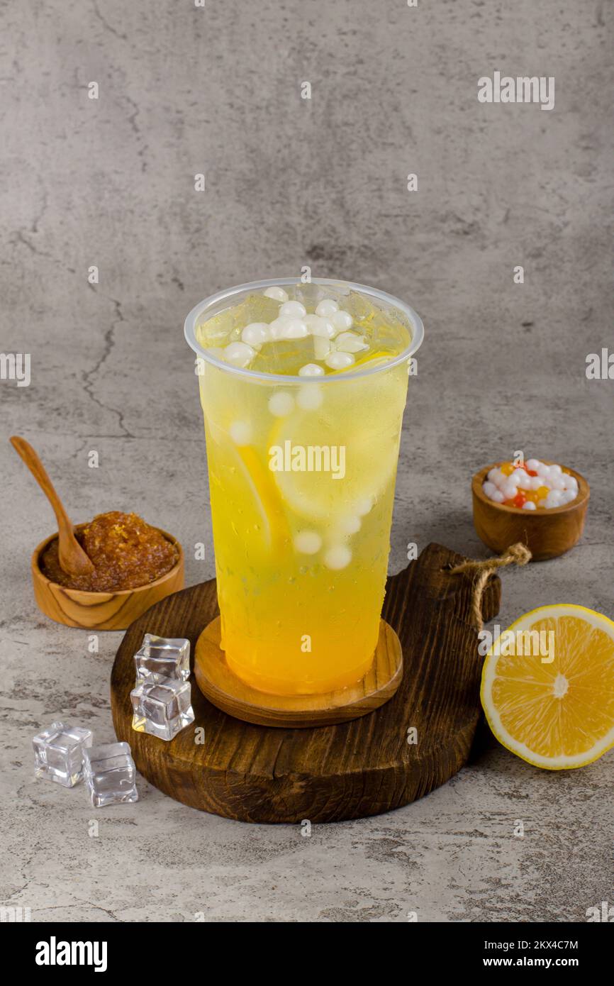 https://c8.alamy.com/comp/2KX4C7M/boba-or-tapioca-pearls-is-taiwan-bubble-milk-tea-in-plastic-cup-with-lemonade-flavor-on-texture-background-summers-refreshment-2KX4C7M.jpg