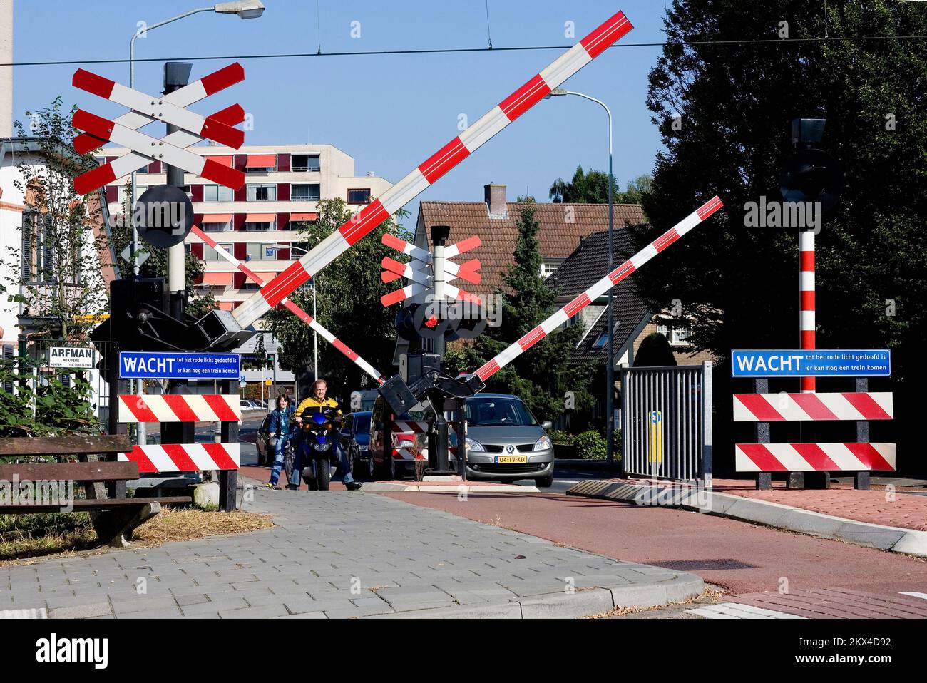 Netherlands, Velp. Railway crossing with barriers and flashing lights. Stock Photo