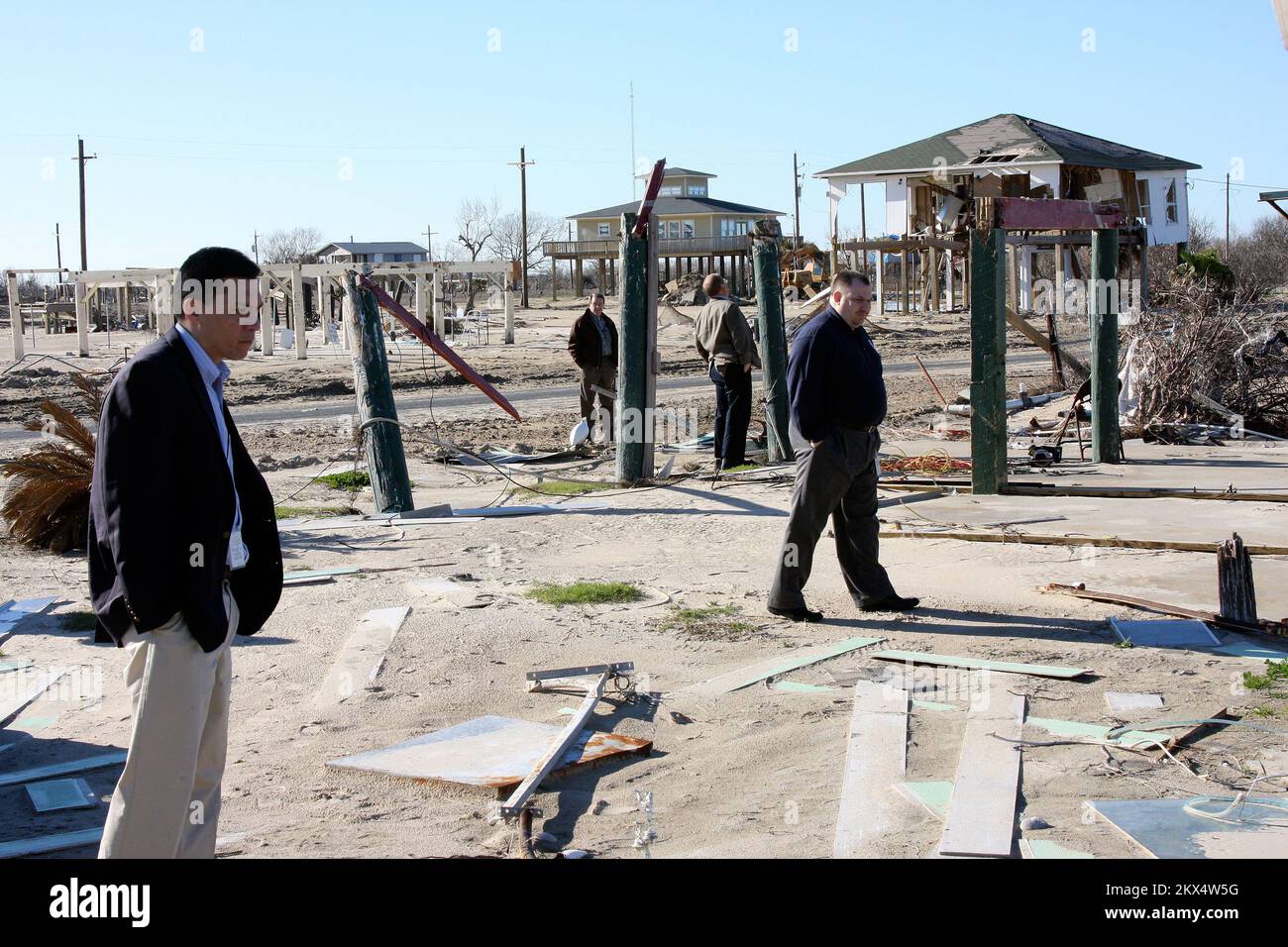 Hurricane/Tropical Storm - Bolivar, Texas, January 12, 2009   Chief Financial Officer Norman Dong (left) surveys damage to a community in Bolivar, Texas while touring the area with representatives from FEMA in Galveston. This beach front neighborhood was destroyed by Hurricane Ike and remains in ruins. Robert Kaufmann/FEMA. Texas Hurricane Ike. Photographs Relating to Disasters and Emergency Management Programs, Activities, and Officials Stock Photo