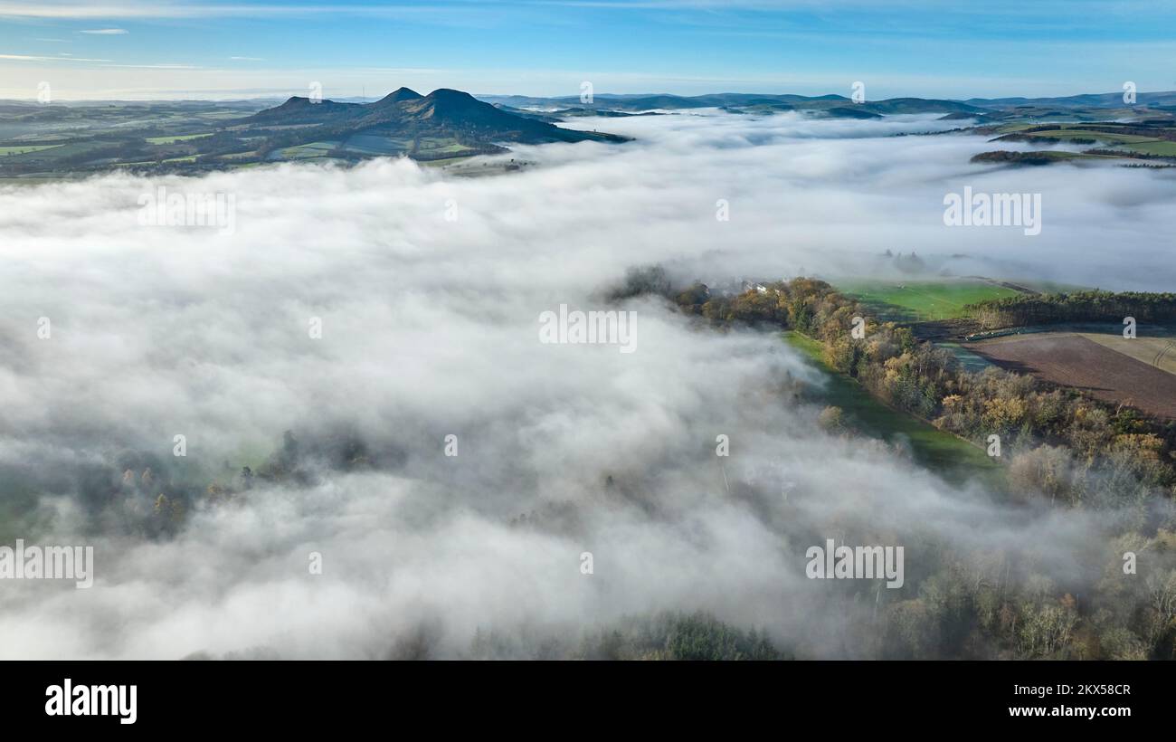 Aerial view of a cloud inversion around the Eildons and the River Tweed from above Scott's View on a sunny November day. Stock Photo