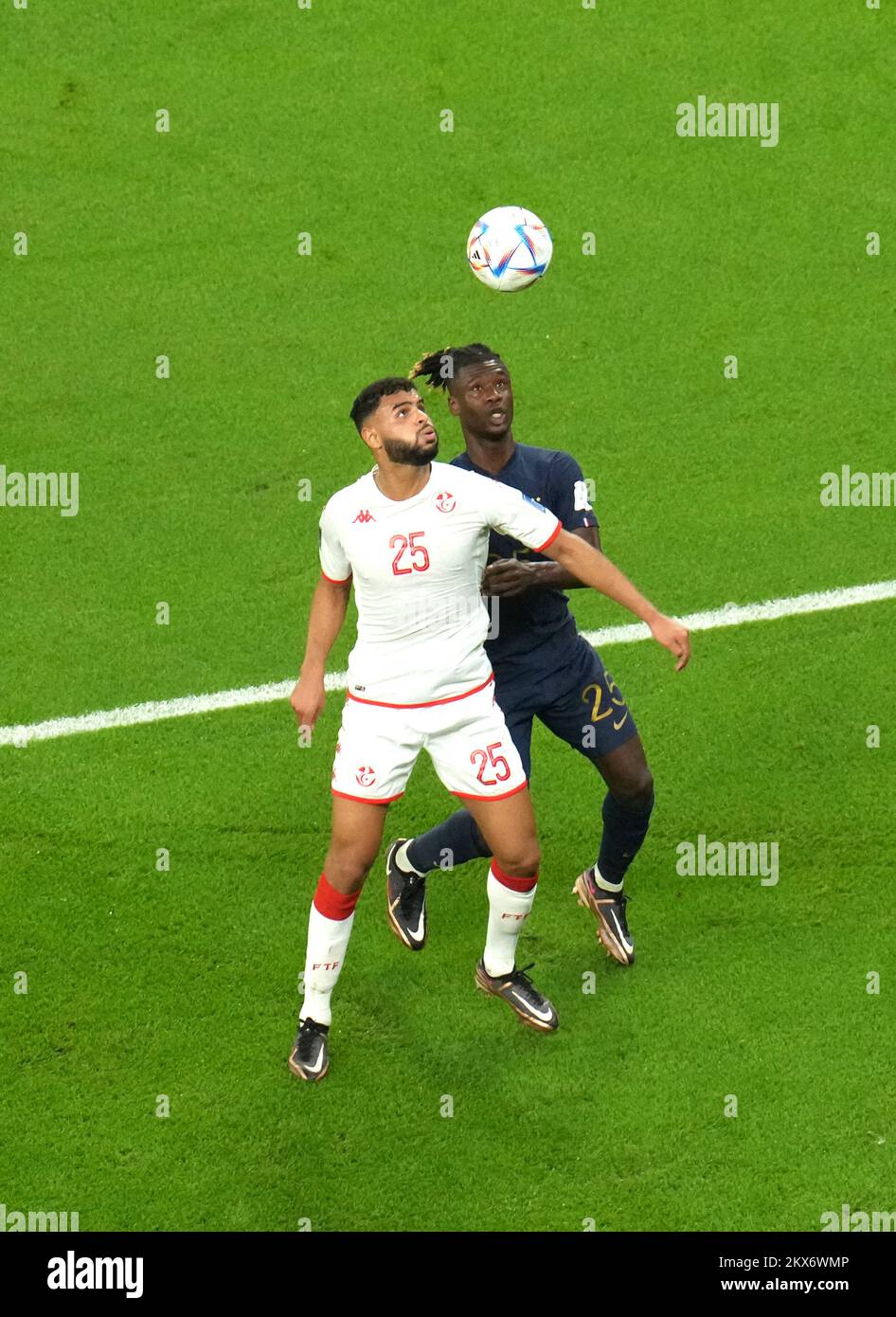 Tunisia's Anis Ben Slimane (left) and France's Eduardo Camavinga battle for the ball during the FIFA World Cup Group D match at the Education City Stadium in Al Rayyan, Qatar. Picture date: Wednesday November 30, 2022. Stock Photo