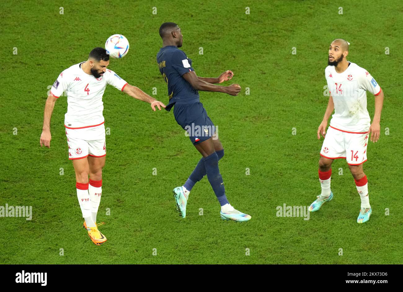 France's Randal Kolo Muani (centre) battles for the ball with Tunisia's Yassine Meriah (left) and Aissa Laidouni during the FIFA World Cup Group D match at the Education City Stadium in Al Rayyan, Qatar. Picture date: Wednesday November 30, 2022. Stock Photo