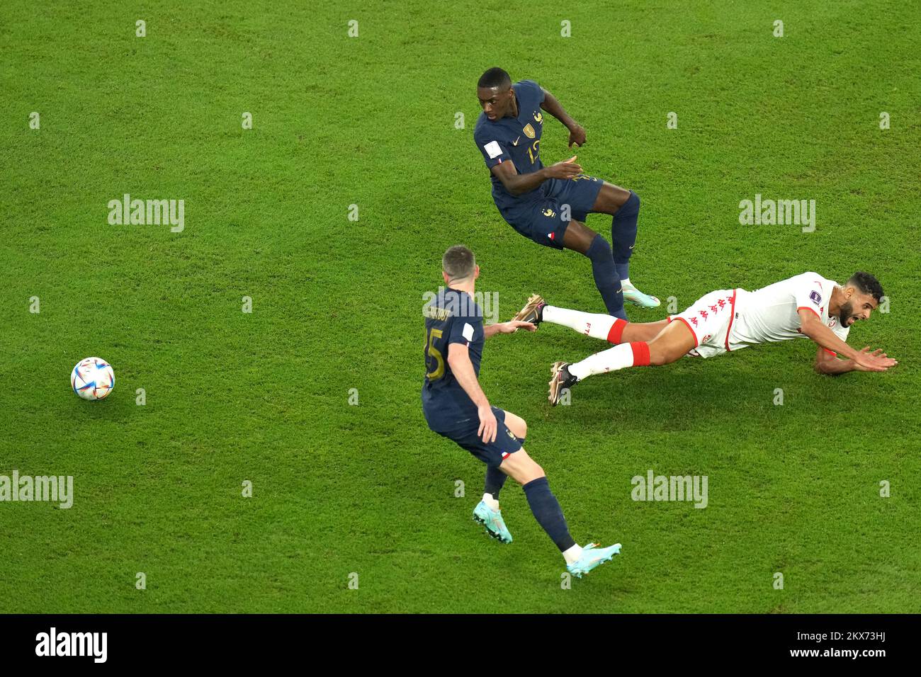 Tunisia's Anis Ben Slimane on the touchline battles for the ball with France's Randal Kolo Muani and Jordan Veretout (bottom) during the FIFA World Cup Group D match at the Education City Stadium in Al Rayyan, Qatar. Picture date: Wednesday November 30, 2022. Stock Photo