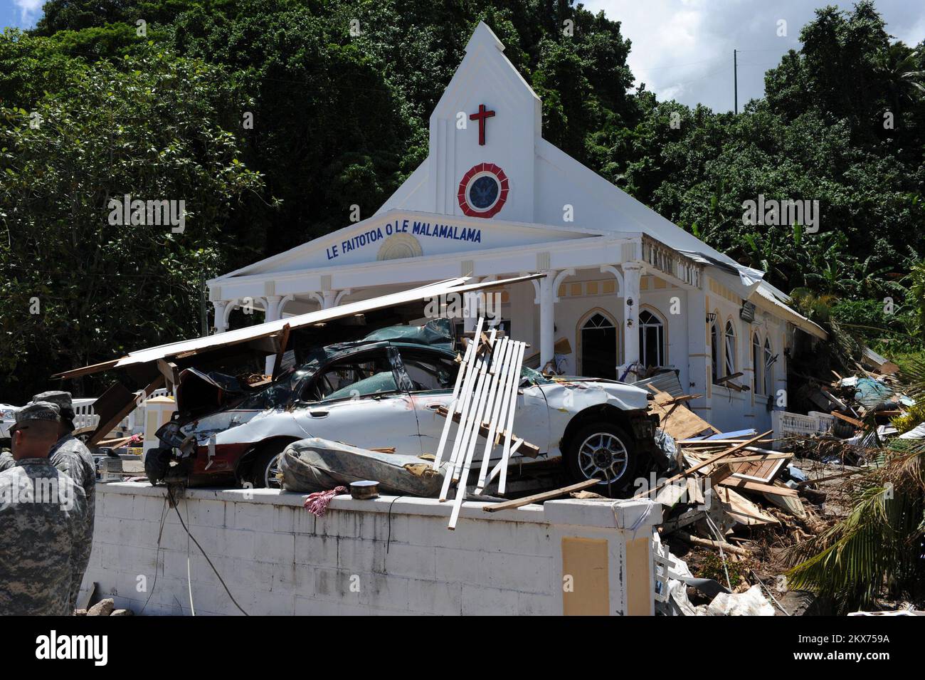 Earthquake   Tsunami - Leone, American Samoa, October 2, 2009   Debris of every kind is spread across the yard of a church. The power of the recent tsunami is demonstrated by this car which was pushed uphill to the front of a church.. American Samoa Earthquake, Tsunami, and Flooding. Photographs Relating to Disasters and Emergency Management Programs, Activities, and Officials Stock Photo
