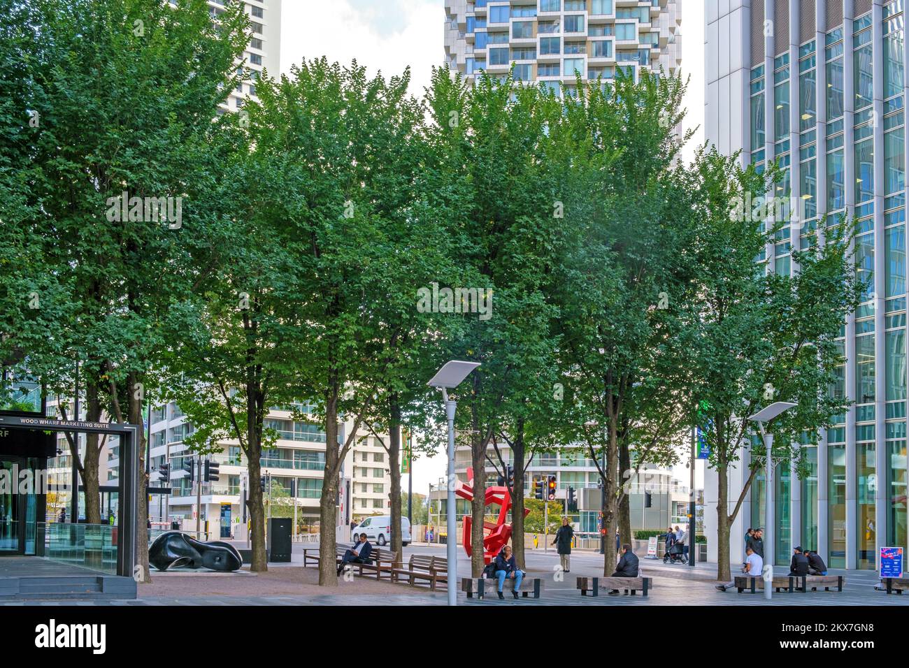 People relax at Montgomery Square at Wood Wharf, Canary Wharf’s new district with benches and public art. Stock Photo