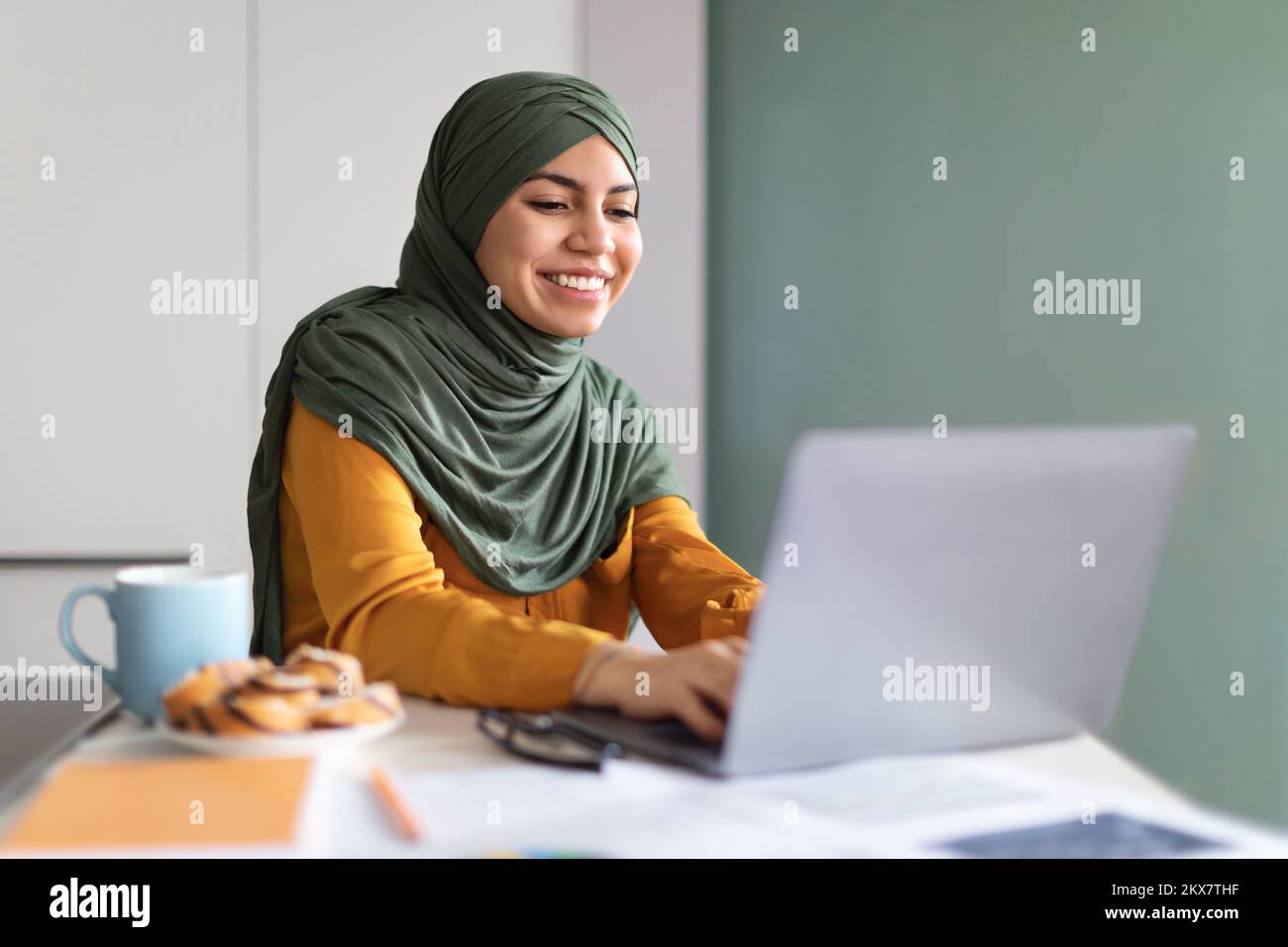 Online Education. Smiling Young Muslim Woman In Hijab Using Laptop At ...
