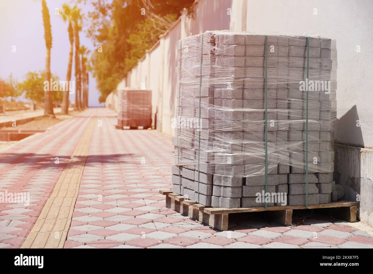 Paving stones on wooden pallet on the street sidewalk. Construction