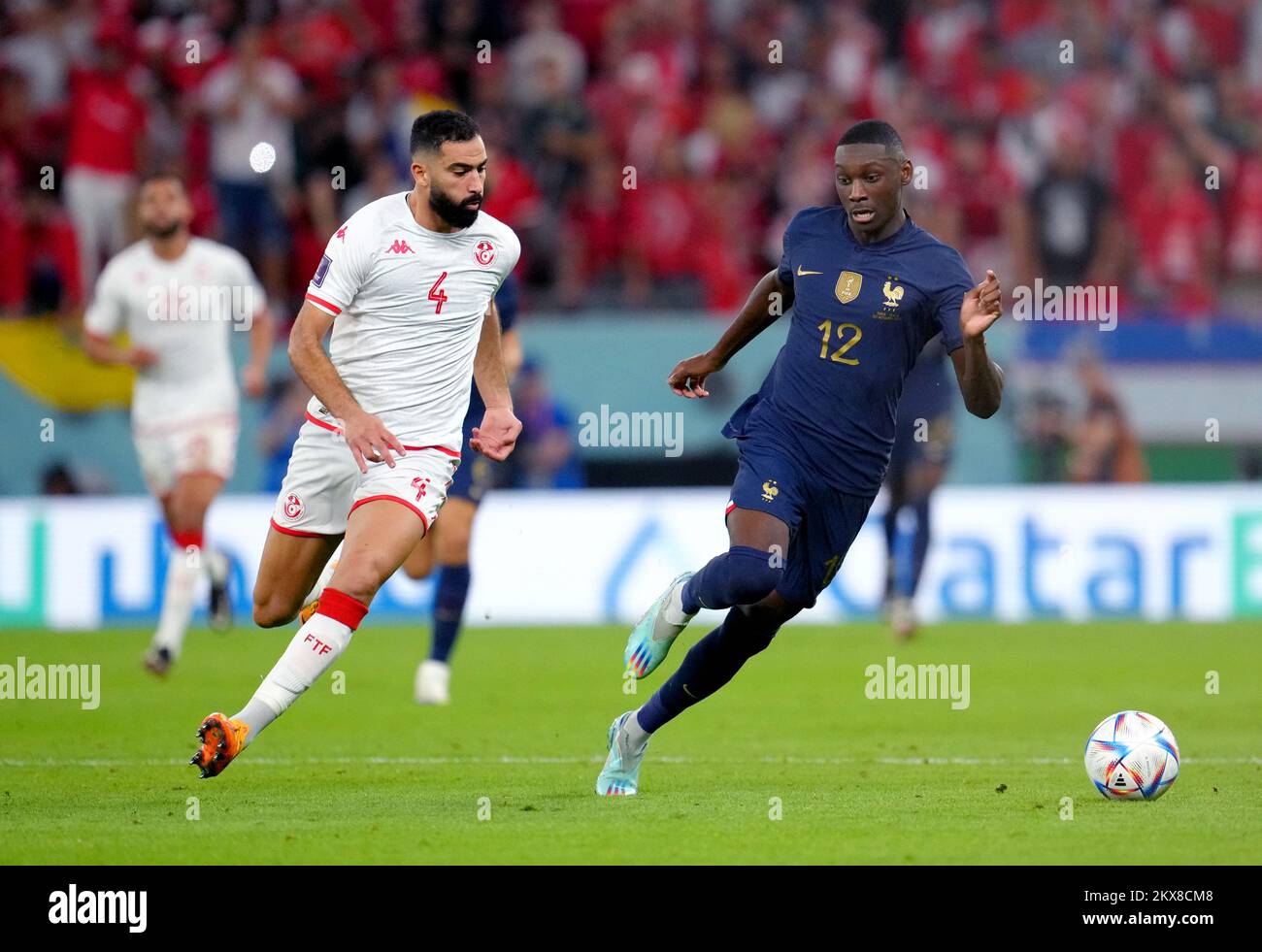 Tunisia's Yassine Meriah (left) and France's Randal Kolo Muani battle for the ball during the FIFA World Cup Group D match at the Education City Stadium in Al Rayyan, Qatar. Picture date: Wednesday November 30, 2022. Stock Photo