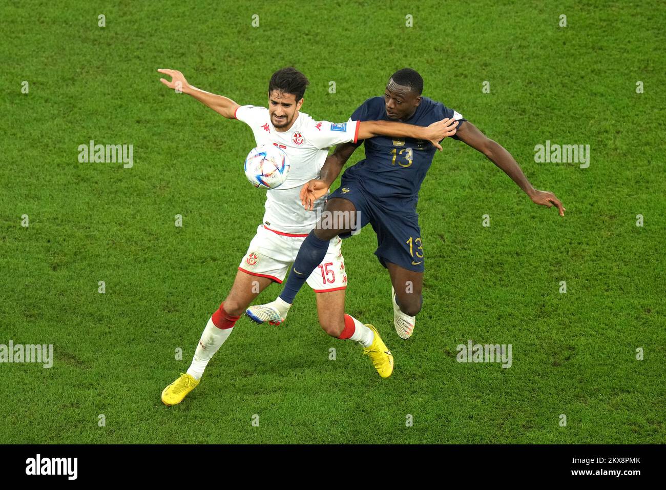 Tunisia's Mohamed Ali Ben Romdhane (left) and France's Youssouf Fofana battle for the ball during the FIFA World Cup Group D match at the Education City Stadium in Al Rayyan, Qatar. Picture date: Wednesday November 30, 2022. Stock Photo