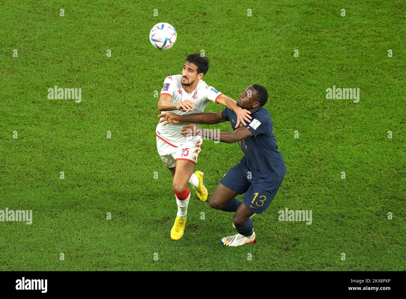 Tunisia's Mohamed Ali Ben Romdhane (left) and France's Youssouf Fofana battle for the ball during the FIFA World Cup Group D match at the Education City Stadium in Al Rayyan, Qatar. Picture date: Wednesday November 30, 2022. Stock Photo