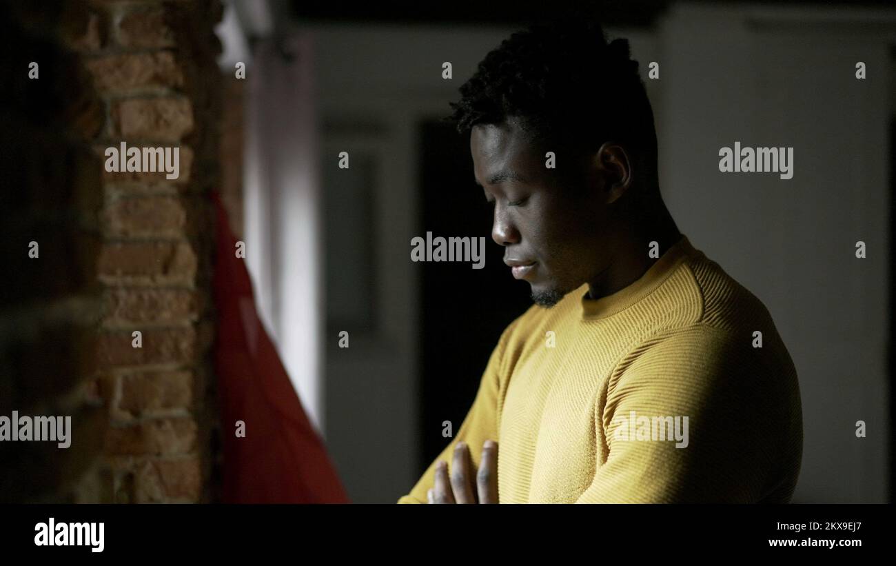 Pensive black African man standing by window, close-up face thinking2 Stock Photo