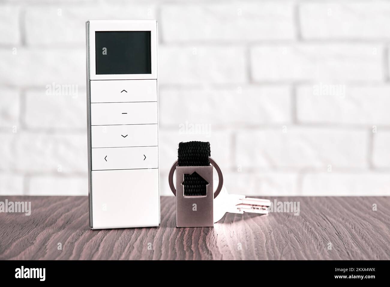 Remote wireless digital security controller and door keys on the table. Security and safety