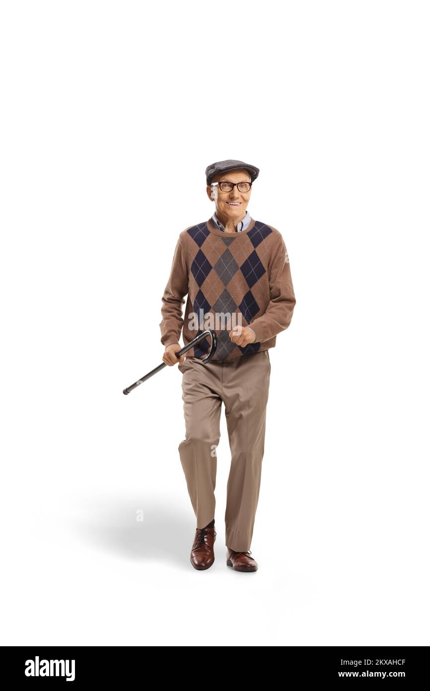 Happy elderly man walking and holding a cane isolated on white ...