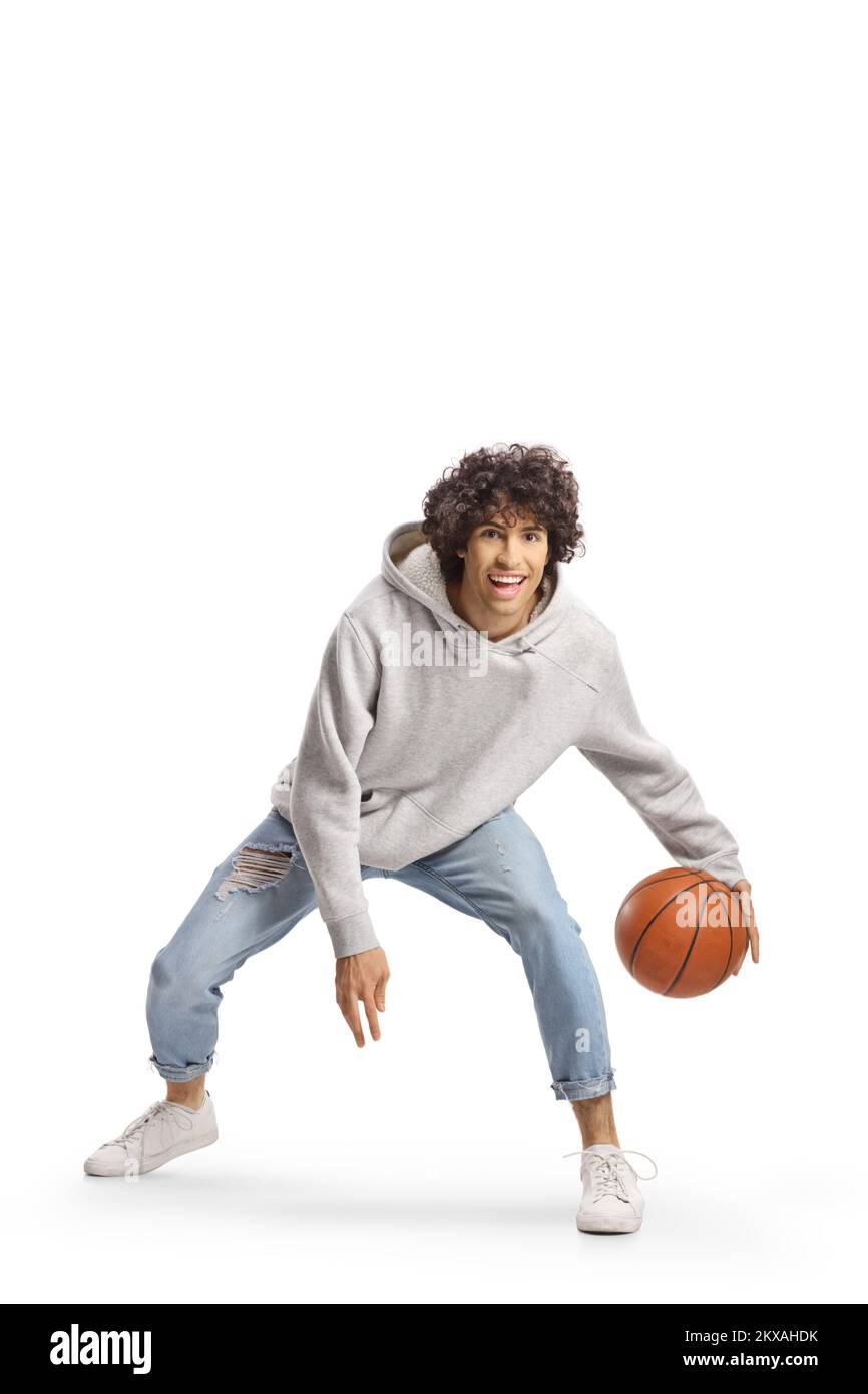 Young man in jeans playing basketball isolated on white background Stock Photo