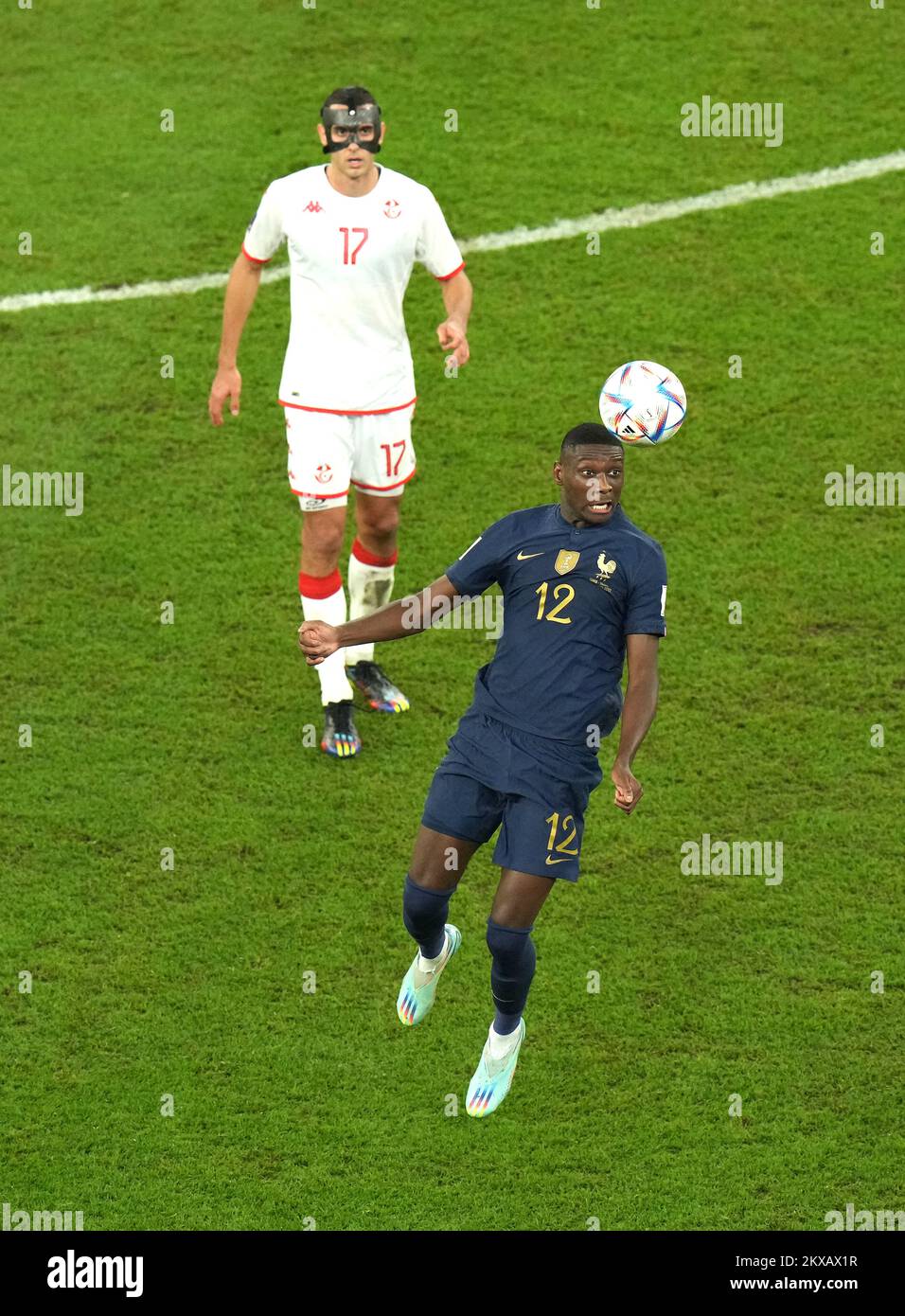 France's Randal Kolo Muani (right) heads the ball clear from Tunisia's Ellyes Skhiri during the FIFA World Cup Group D match at the Education City Stadium in Al Rayyan, Qatar. Picture date: Wednesday November 30, 2022. Stock Photo