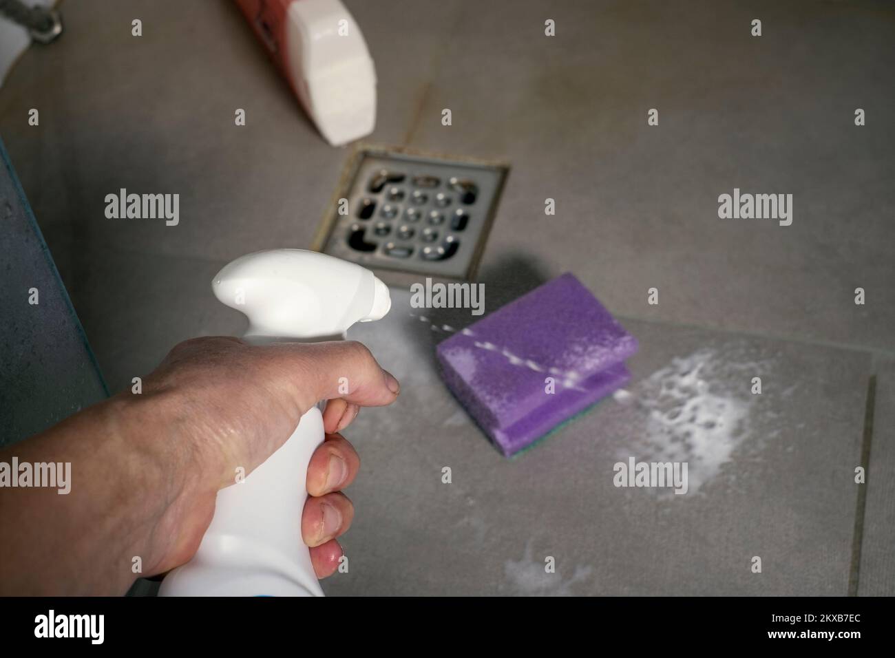 closeup of a male hand cleaning a bathroom floor with household ammonia Stock Photo Alamy