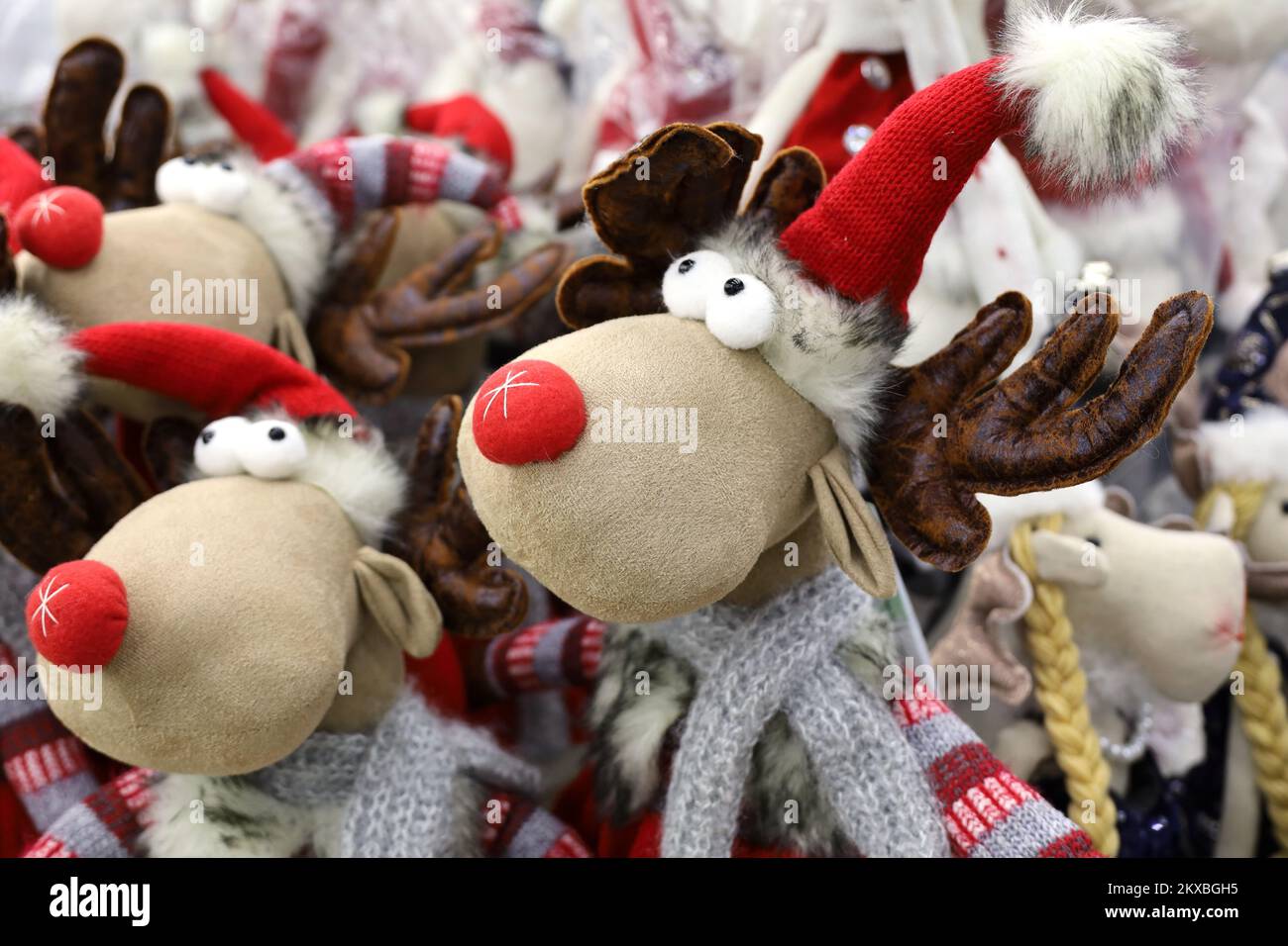 Christmas toys in a store. Stuffed deer figures, New Year gifts for winter holidays Stock Photo