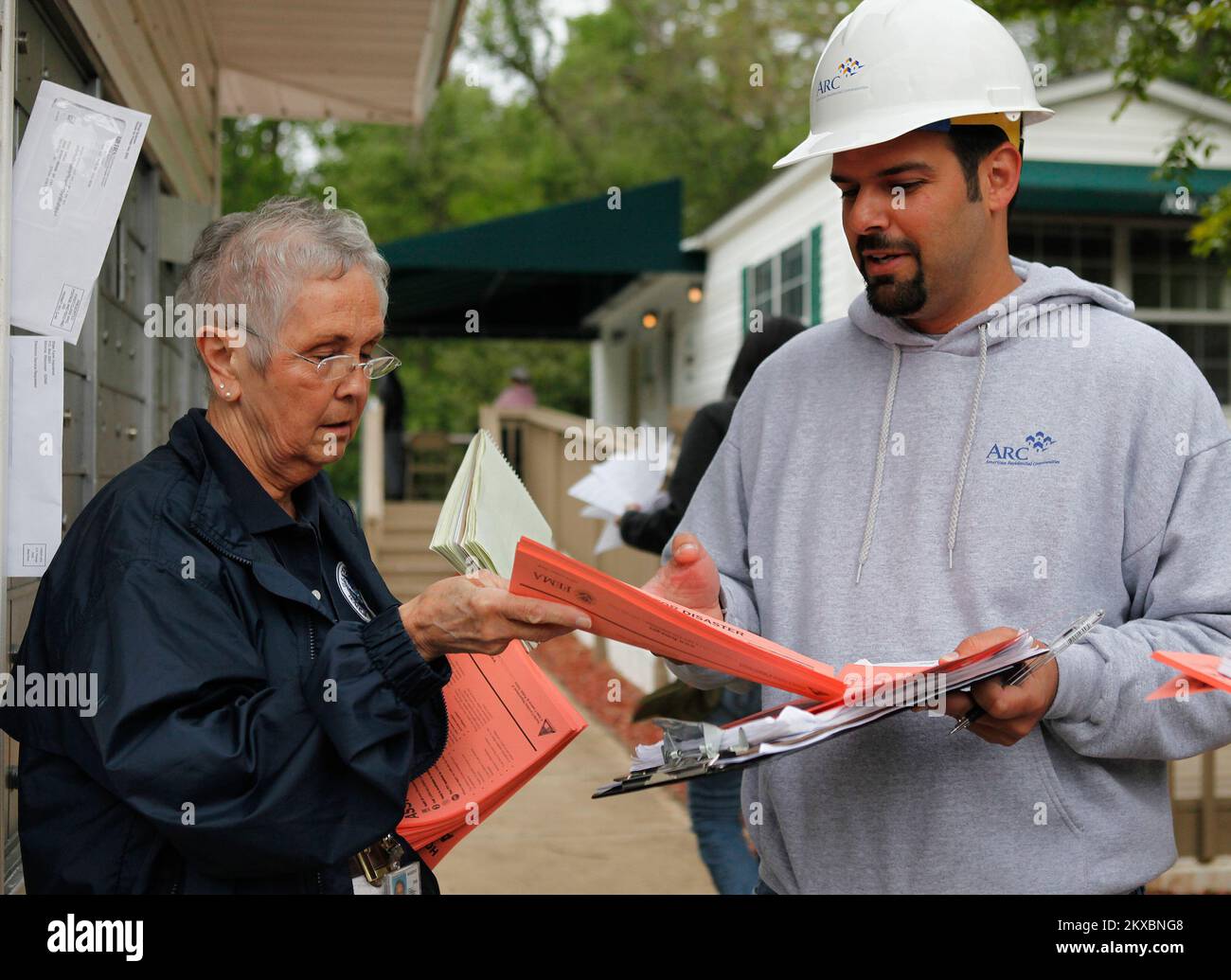 Tornado - Raleigh, N. C. , April 22, 2011   FEMA Community Relations Sheila Kosier confers with the neighborhood district manager as her team prepares to contact residents of a severely damaged neighborhood in North Carolina following the severe storms and deadly tornadoes that damaged or destroyed homes and businesses across North Carolina on April 16, 2011. David Fine/FEMA. North Carolina Severe Storms, Tornadoes, And Flooding. Photographs Relating to Disasters and Emergency Management Programs, Activities, and Officials Stock Photo