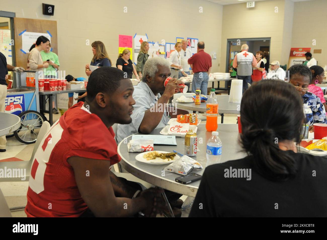 Tornado - Tuscaloosa, Ala. , May 6, 2011   University of Alabama Football All-American Javier Arenas has lunch with volunteers at the Tuscaloosa Red Cross Shelter. Javier passed out FEMA registration flyers, signed autographs, and posed for pictures with fans to help raise the spirits of people who have lost nearly everything. FEMA Photo /Tim Burkitt.. Photographs Relating to Disasters and Emergency Management Programs, Activities, and Officials Stock Photo