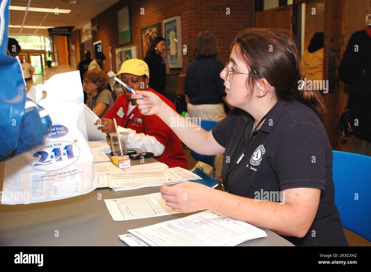 Tornado - Ferguson, Mo. , May 14, 2011   Jessica Callahan, a member of the coordinated service team of Americorps, assists tornado survivors with their check-in at the Multi-Agency Resource Center (MARC) held Saturday, May 14, 2011. Nineteen area agencies participated in the roundup held at the Florissant Valley Community College. Over 1500 survivors participated in the event. The Greater St. Louis area was struck by tornadoes and storms on April 22. Jace Anderson/FEMA.. Photographs Relating to Disasters and Emergency Management Programs, Activities, and Officials Stock Photo