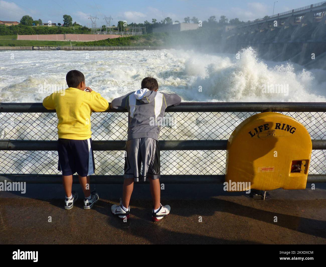 Flooding - Pierre, S. D. , June 11, 2011   Two boys watch the roiling water of the Missouri River created by increased releases at Gavins Dam north of Yankton, SD. FEMA and other federal agencies are supporting the State Incident Management Team in their effort to respond to flooding along the river.. South Dakota Flooding. Photographs Relating to Disasters and Emergency Management Programs, Activities, and Officials Stock Photo