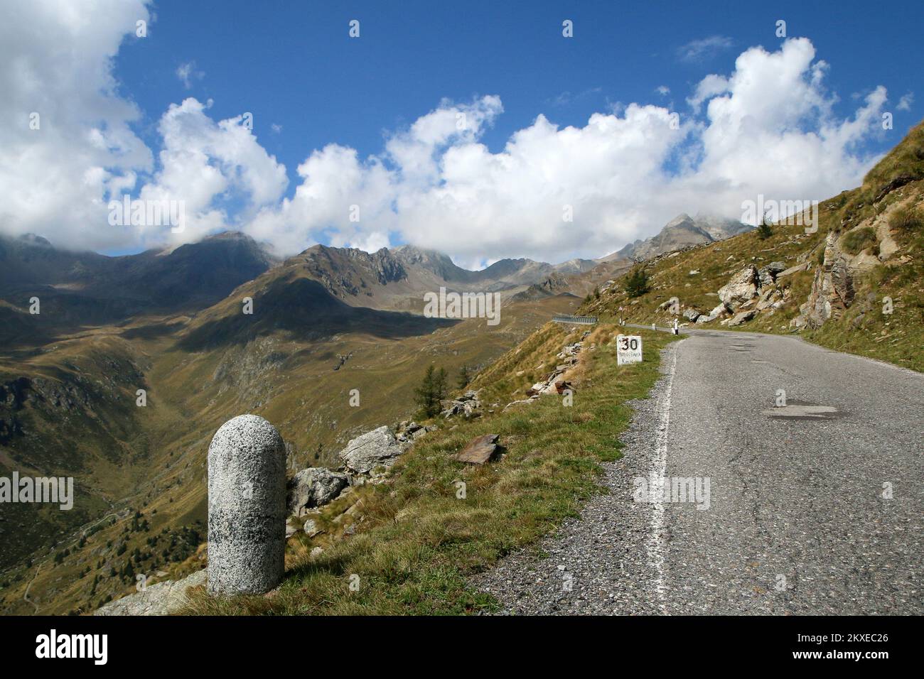 The view of the road climbing to the Passo di Gavia in Italy. The narrow and challenging road towards the summit. Stock Photo