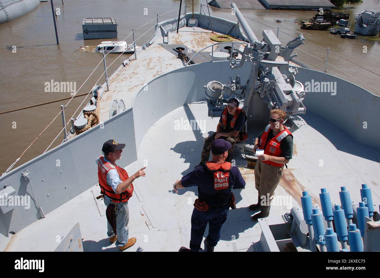 Flooding - Omaha, Neb. , July 2, 2011   Duane Gallagher, Chief Volunteer of the USS Hazard since 1984, other volunteers and members of the U. S. Coast Guard discuss the state of artifacts on the Hazard following flooding of the Misouri River. The Coast Guard provided a flat bottom boat for the volunteers to search the area to identify positions of the submerged objects. Jace Anderson/FEMA.. Photographs Relating to Disasters and Emergency Management Programs, Activities, and Officials Stock Photo