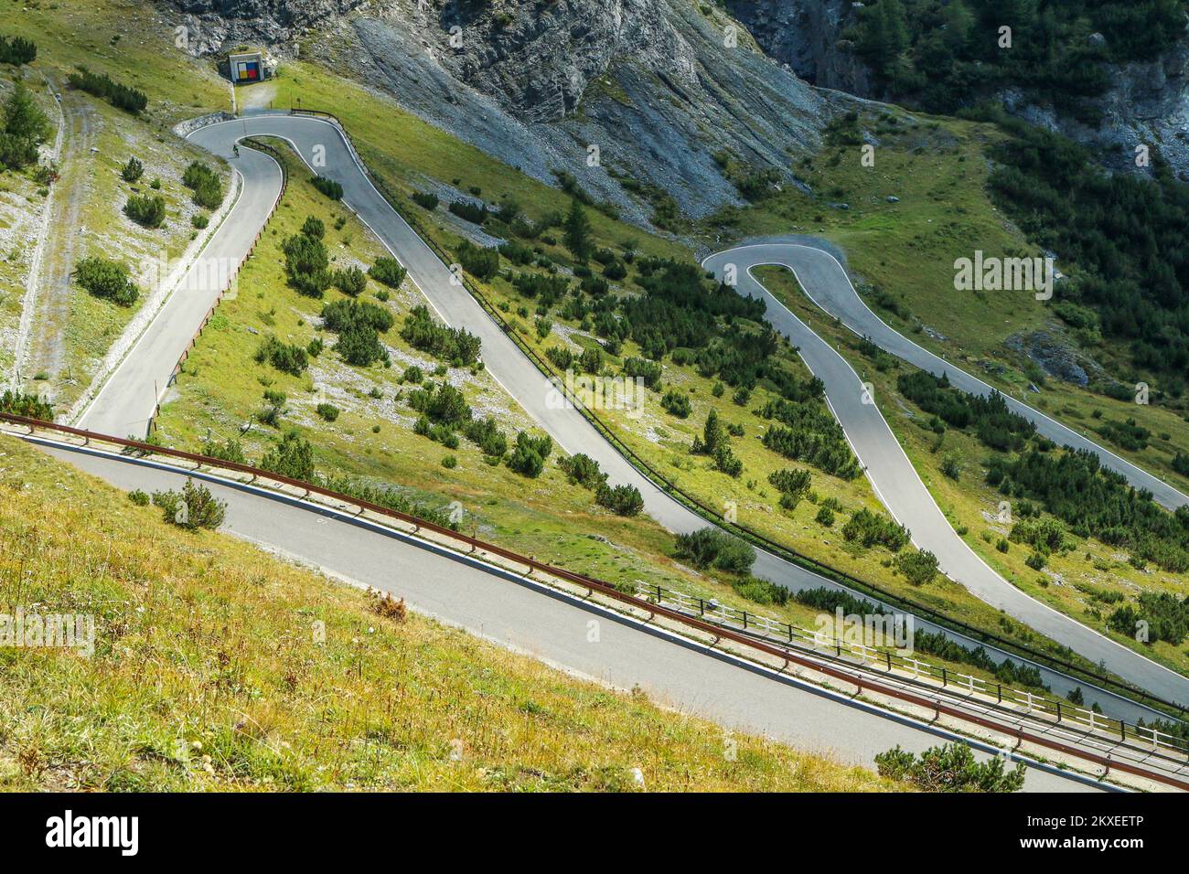 The detail of the hairpins of the challenging road towards the famous Stelvio Pass in the italian Alps, close to Switzerland. Stock Photo