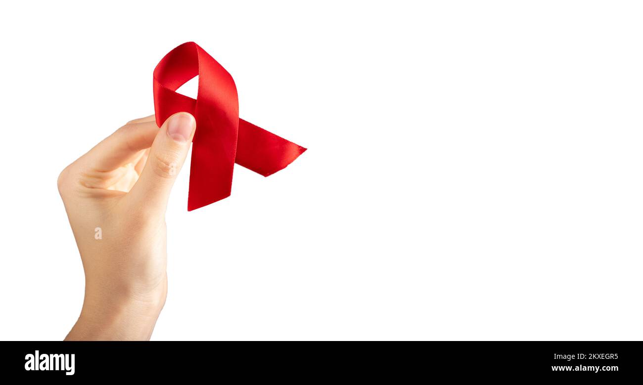 Red ribbon loo in hand isolated on white background for 1 December ...