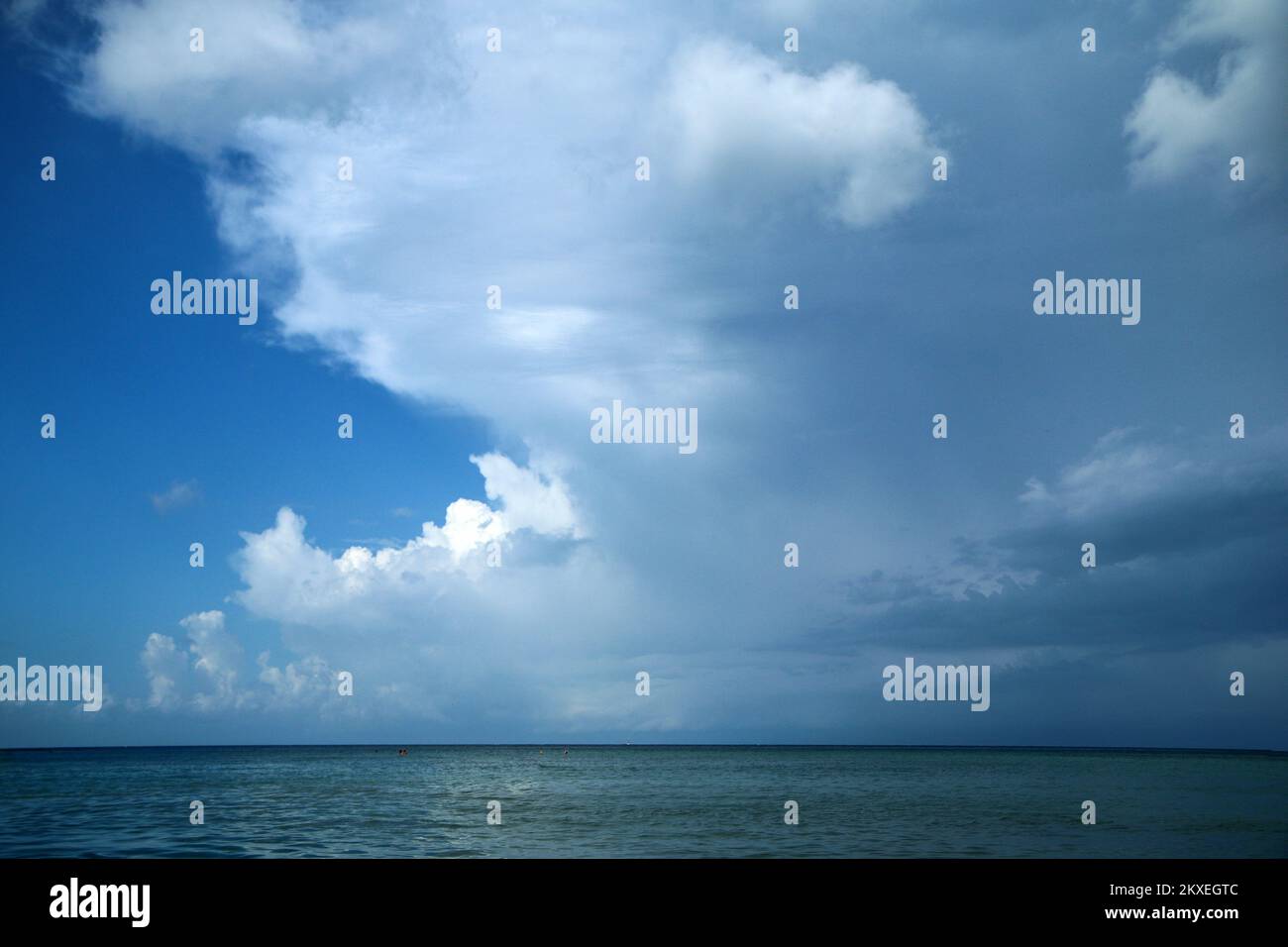 The detail of the front above the ocean surface with a dramatic change from sunny day to the rainy area. Stock Photo