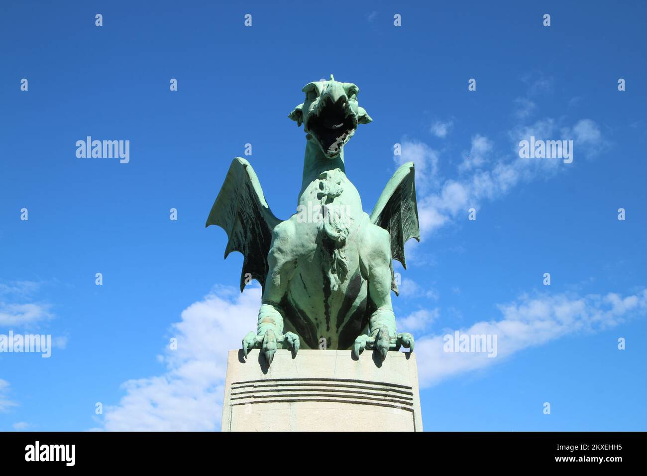 Dragon statue standing on the Dragon bridge in Ljubljana in Slovenia during the nice and sunny day. Stock Photo