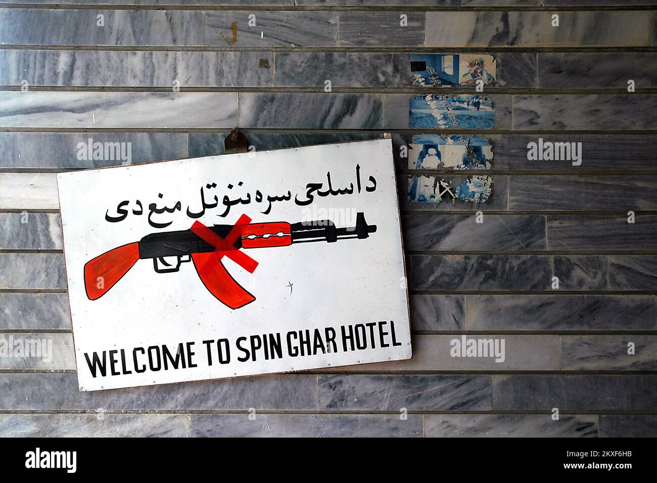 Jalalabad, Nangarhar Province / Afghanistan: No Guns Allowed sign outside the Spinghar Hotel in Jalalabad showing a gun with a red cross through it. Stock Photo