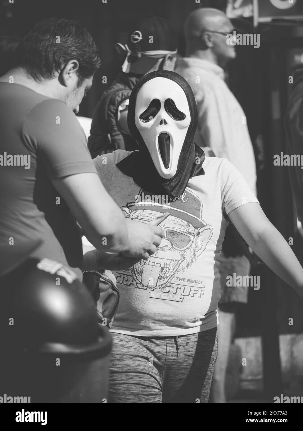 Bucharest, Romania - Man wearing a ghost face scream mask. Street photography in Bucharest. Stock Photo