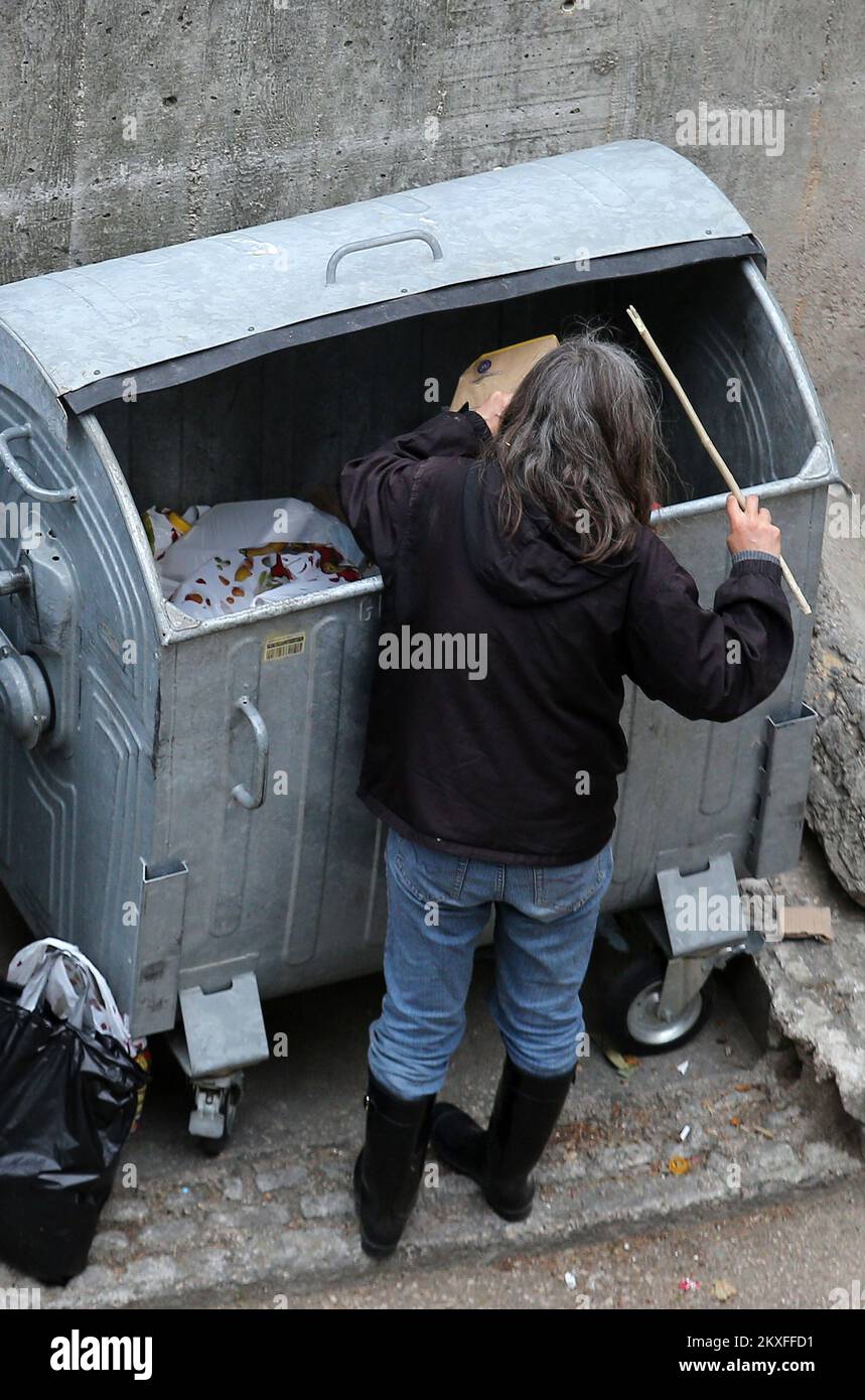 21.04.2020., Sibenik, Croatia - Poor man digging out of garbage. The ...