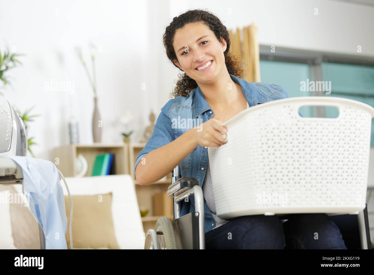 happy woman in wheelchair holding basket Stock Photo Alamy